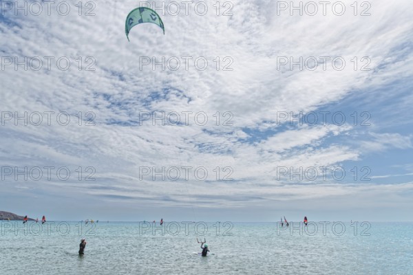 Prasonisi's expansive sea under a big sky with kitesurfers. Lively, sporty atmosphere, Prasonisi, Rhodes Island, Greece