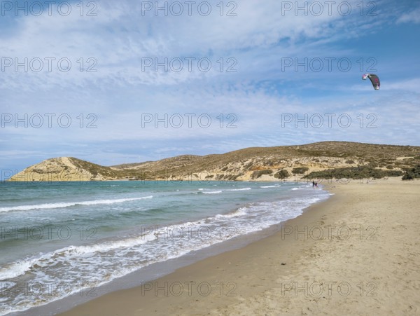 Quiet beach of Prasonisi with gentle waves and a kite in the sky under a slightly cloudy sky, conveys serenity and freedom, Prasonisi, Rhodes Island, Greece