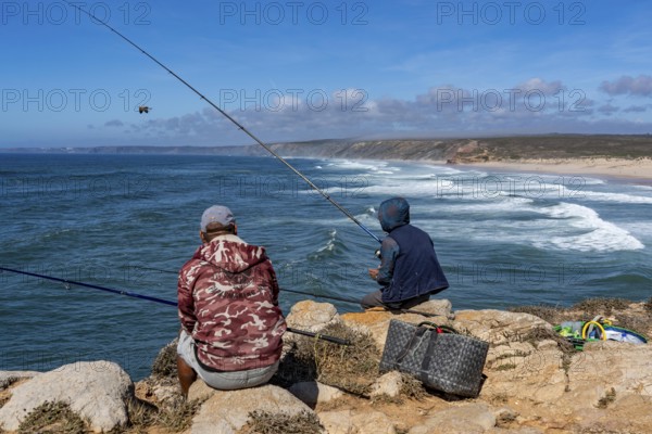 Anglers on the cliffs at the viewpoint above Praia da Bordeira beach, near Carrapateira, popular with surfers, surfers, rocky coast, cliffs in the south-west of the Algarve, Portugal