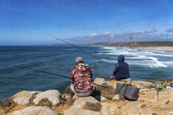 Anglers on the cliffs at the viewpoint above Praia da Bordeira beach, near Carrapateira, popular with surfers, surfers, rocky coast, cliffs in the south-west of the Algarve, Portugal