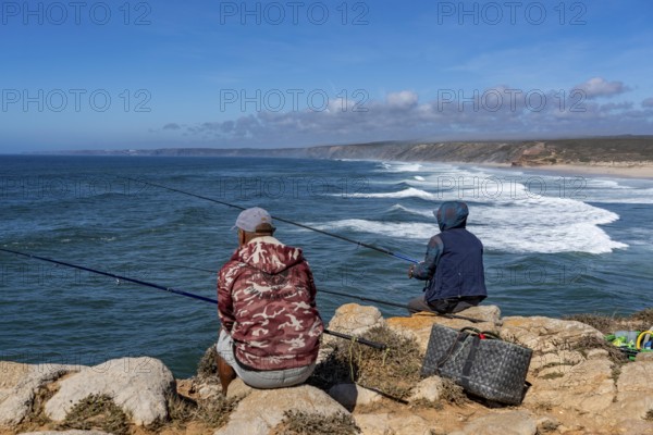 Anglers on the cliffs at the viewpoint above Praia da Bordeira beach, near Carrapateira, popular with surfers, surfers, rocky coast, cliffs in the south-west of the Algarve, Portugal
