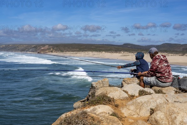 Anglers on the cliffs at the viewpoint above Praia da Bordeira beach, near Carrapateira, popular with surfers, surfers, rocky coast, cliffs in the south-west of the Algarve, Portugal