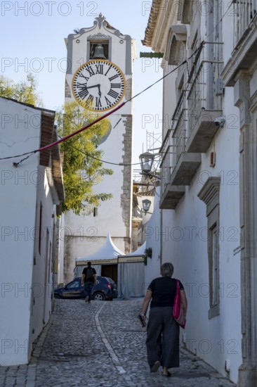 Old town alleys, catholic church Igreja de Santa Maria do Castelo in Tavira, in the Algarve, Portugal