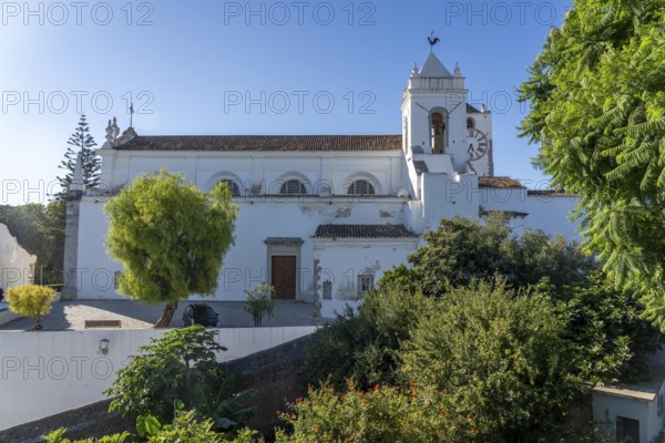 Old town alleys, catholic church Igreja de Santa Maria do Castelo in Tavira, in the Algarve, Portugal