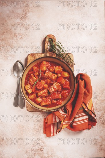 Meat goulash with potatoes and carrots, sweet peppers, in a saucepan, top view, traditional Hungarian soup, homemade, no people