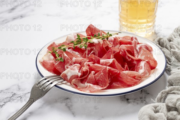 Plate with sliced cured meat, pork neck, prosciutto coppa, Italian delicacy