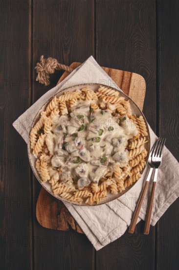 Fusilli pasta, with champignons in creamy garlic sauce, with herbs and spices, sauce, no people
