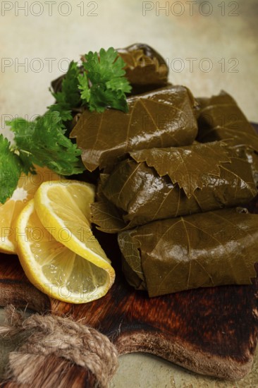 Dolma, minced meat with rice, in grape leaves, minced meat rolls, on a chopping board, top view, no people