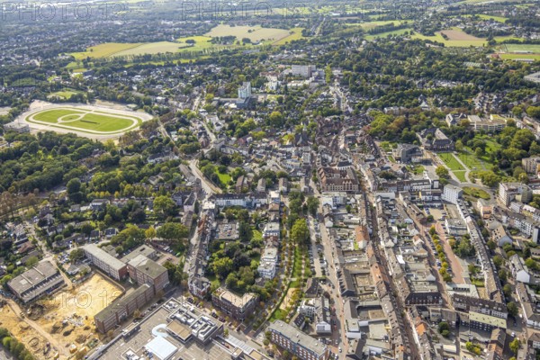 Aerial view, city centre with shopping street Kolpingstraße, Protestant city church and city library, Altmarkt and St. Vincentius church, former harness racing track on the left, below Dinslaken vocational college with construction site for new school complex, behind GFO Kliniken Niederrhein - St. Vinzenz Hospital, Dinslaken, Ruhr area, North Rhine-Westphalia, Germany, place of worship, vocational school, education, educational institution, DE, Europe, healthcare, religious community, place of worship, property tax, Hanseatic city, holy site, hospital, real estate, church, parish, clinic, hospital centre, denomination, hospital, Hospital, Teaching institute, Aerial view, Aerial photography, Aerial photography, Medical facility, Medical aid, Lower Rhine, Religion, Religious site, School, Overview, Bird's-eye view, Living and living, Residential area, Residential quality, Residential neighbourhood, Residential area, Bird's-eye view, Overview, Medical care