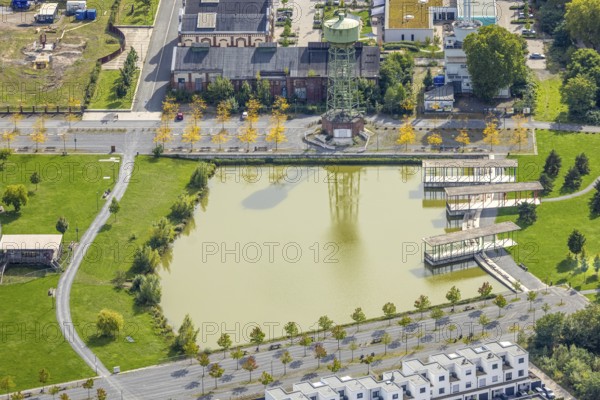 Aerial view, Bergpark Lohberg Kreativquartier, former colliery site and landscaping, Lohberger Weiher with water tower and shadows, Oberlohberg, Dinslaken, Ruhr area, North Rhine-Westphalia, Germany, DE, Europe, Hanseatic city, creative quarter, aerial view, aerial photography, aerial photography, Lower Rhine, tower, overview, bird's eye view, colliery, birds-eyes view, former colliery, overview