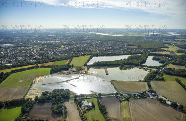 Aerial view, Schwarzer Weg quarry pond, view of Voerde and Voerde power station, Bruckhausen, Hünxe, Ruhr area, North Rhine-Westphalia, Germany, DE, Europe, distant view, aerial view, aerial photography, aerial photography, Lower Rhine, lake, overview, bird's eye view, birds-eyes view, blue sky, overview