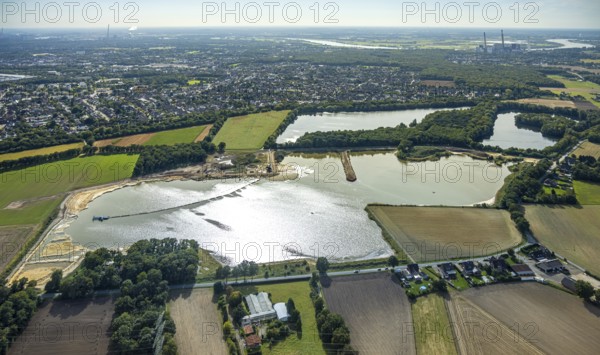 Aerial view, Schwarzer Weg quarry pond, view of Voerde and Voerde power station, Bruckhausen, Hünxe, Ruhr area, North Rhine-Westphalia, Germany, DE, Europe, distant view, aerial view, aerial photography, aerial photography, Lower Rhine, lake, overview, bird's eye view, birds-eyes view, blue sky, overview