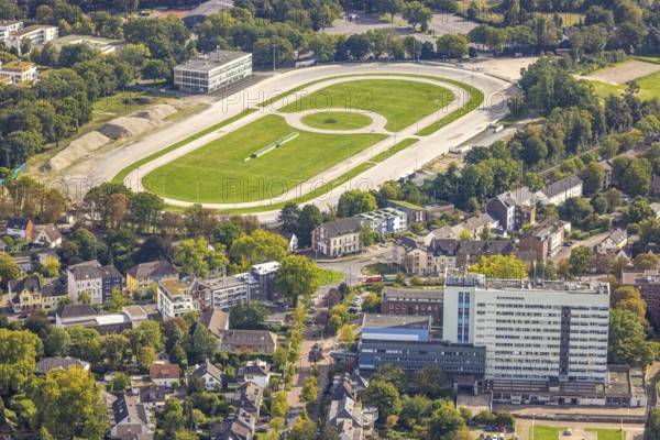 Aerial view, former trotting track Dinslaken with demolition works and construction site for a new residential quarter, Bärenkampallee, Dinslaken, Ruhr area, North Rhine-Westphalia, Germany, demolition works, architecture, view, construction equipment, construction site, DE, Europe, land use, progress, building, Hanseatic city, infrastructure, construction, landscape, aerial view, aerial photography, aerial photography, modernisation, new construction, Lower Rhine, levelling, planning, trotting track, overview, urbanisation, change, bird's-eye view, housing construction, birds-eyes view, new residential quarter, overview