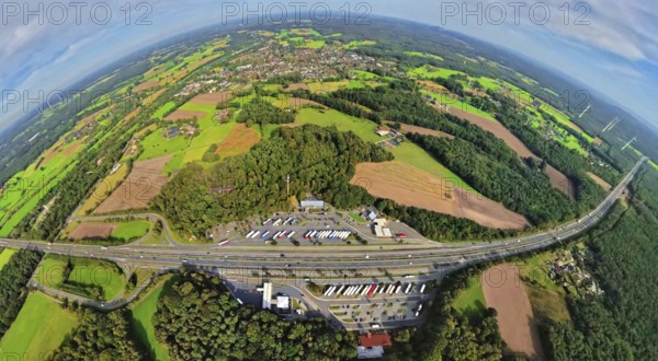 Aerial view, service area Hünxe-Ost and Hünxe-West, petrol station and rest area with truck parking on the A3 motorway and Hünxe junction, meadows and fields with forest area, globe, fisheye image, fisheye image, 360 degree image, tiny world, little planet, fisheye image, Hünxe, Ruhr area, North Rhine-Westphalia, Germany, DE, Europe, fisheye lens, fisheye lens, truck stop, Little Planet, aerial photography, aerial photography, aerial photography, Lower Rhine, road traffic, super wide angle lens, Tiny World, overview, bird's eye view, forest area, globe, birds-eyes view, fisheye lens, insta360 camera, overview