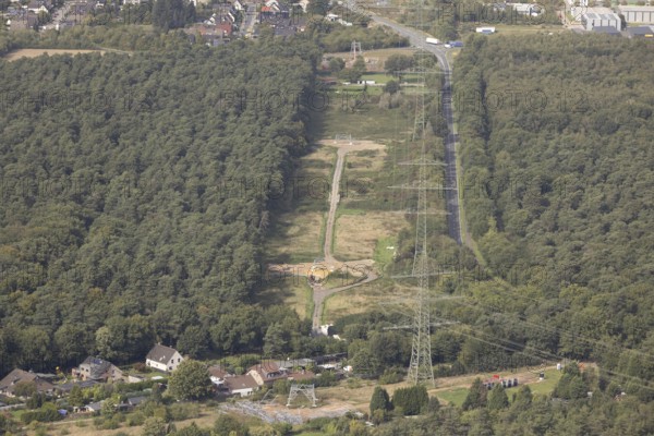 Aerial photo, work on the transmission grid, extra-high-voltage power line, power pylon extension for power line in the Speller Heide forest on Hans-Richter-Straße, Friedrichsfeld, Voerde, Ruhr area, North Rhine-Westphalia, Germany, DE, energy plant, Europe, Hünxe, aerial photo, aerial photography, aerial photography, Lower Rhine, power supply, overview, bird's-eye view, overview