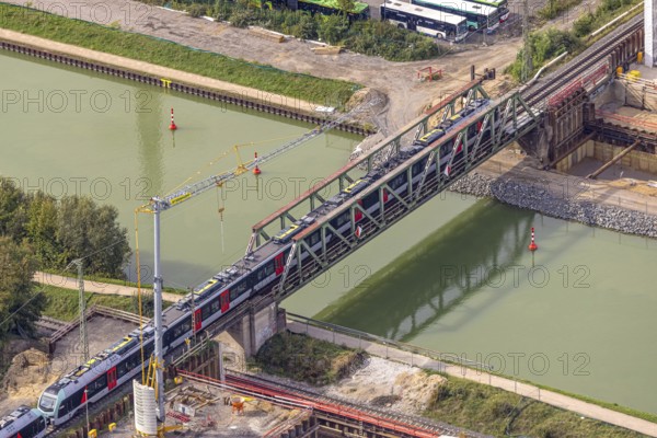 Aerial view, S-Bahn over a railway bridge Wesel-Datteln-Kanal, construction site and demolition of a second railway line with bridge, Friedrichsfeld, Voerde, Ruhr area, North Rhine-Westphalia, Germany, demolition work, construction work, construction area, building site, building plots, construction project, construction site, DE, Europe, aerial view, aerial photography, aerial photography, Lower Rhine, overview, Voerde (Lower Rhine), bird's eye view, birds-eyes view, overview