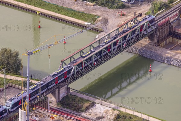 Aerial view, S-Bahn over a railway bridge Wesel-Datteln-Kanal, construction site and demolition of a second railway line with bridge, Friedrichsfeld, Voerde, Ruhr area, North Rhine-Westphalia, Germany, demolition work, construction work, construction area, building site, building plots, construction project, construction site, DE, Europe, aerial view, aerial photography, aerial photography, Lower Rhine, overview, Voerde (Lower Rhine), bird's eye view, birds-eyes view, overview