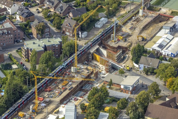 Aerial view, Poststrasse with bridge construction and railway line with S-Bahn, extension of the Betuweroute and Betuwe-Line railway line, Friedrichsfeld, Voerde, Ruhr area, North Rhine-Westphalia, Germany, construction work, construction area, construction site, building plots, construction crane, construction project, construction site, DE, Europe, aerial view, aerial photography, aerial photography, Lower Rhine, overview, Voerde (Lower Rhine), bird's eye view, birds-eyes view, overview