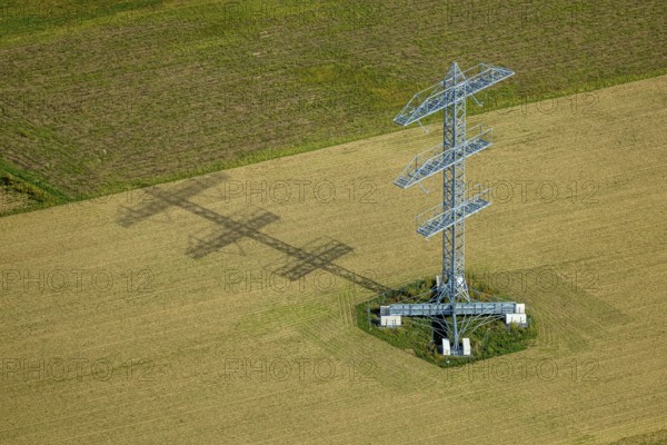 Aerial view, power line project with power pole construction for power line at Hammweg, power pole with shadow on a field, Voerde, Ruhr area, North Rhine-Westphalia, Germany, DE, Europe, aerial view, aerial photography, aerial photography, Lower Rhine, shadow casting, technology and nature, overview, Voerde (Lower Rhine), bird's eye view, birds-eyes view, overview