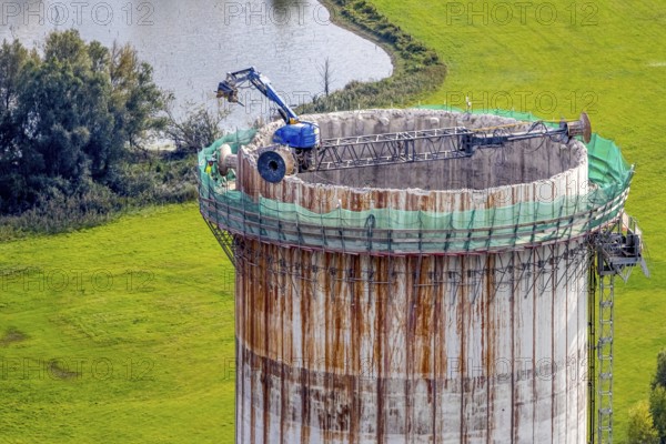 Aerial view, construction site with dismantling work on a tower of the Voerde power plant, Möllen, Voerde, Ruhr area, North Rhine-Westphalia, Germany, demolition work, excavator, construction work, construction site, building site, construction project, construction site, DE, Europe, aerial view, aerial photography, aerial photography, Lower Rhine, dismantling, overview, Voerde (Lower Rhine), bird's eye view, bird's eye view, overview