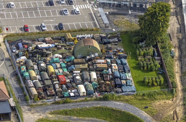 Aerial view, scrap yard with old military trucks at Friedrichsfeld (Lower Rhine) railway station, Friedrichsfeld, Voerde, Ruhr area, North Rhine-Westphalia, Germany, railway area, railway station, platform, DE, Deutsche Bahn AG, Europe, railway tracks, tracks, aerial view, aerial photography, aerial photography, Lower Rhine, scrap trade, overview, Voerde (Lower Rhine), bird's-eye view, recycling, birds-eyes view, overview