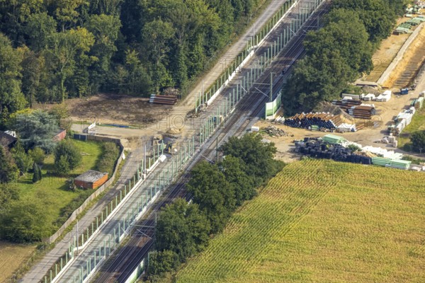 Aerial view, Schwanenstraße level crossing, expansion of the Betuweroute and Betuwe line railway line, construction site with noise barrier expansion, Voerde, Ruhr area, North Rhine-Westphalia, Germany, railway line, construction work, construction area, construction site, building site, construction project, construction site, DE, railway construction, Europe, aerial view, aerial photography, aerial photography, Lower Rhine, overview, Voerde (Lower Rhine), bird's-eye view, bird's-eye view, overview