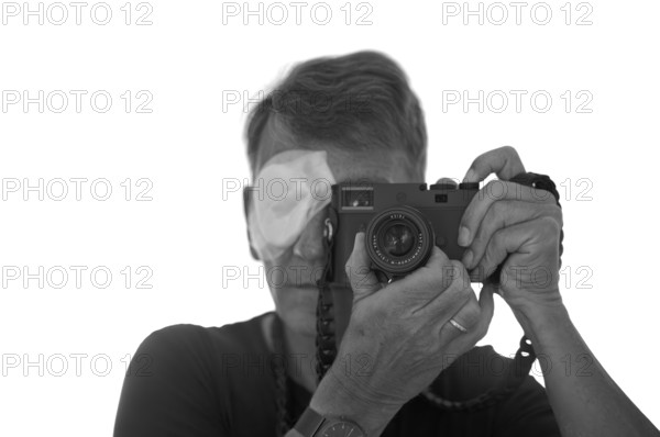 Portrait, self-portrait, selfie, photographer with eye bandage, eye injury, bandage on eye, looking through camera, viewfinder camera, photographed, Leica M11 Monochrom, black and white, Stuttgart, Baden-Württemberg, Germany