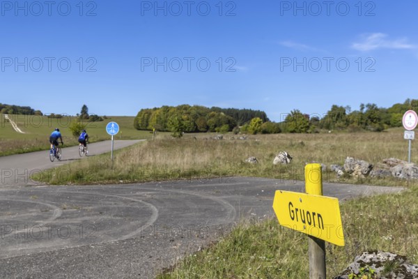 Gruorn is a deserted village near Münsingen in the Swabian Alb. The former village is located in the former military training area and has been part of the newly established Swabian Alb biosphere reserve since 2008. Landscape with signposts and cyclists. Münsingen, Baden-Württemberg, Germany