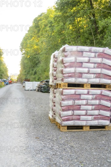 Pallets with building materials on a gravel road surrounded by forest, Hermann Hessebahn construction site, Calw, Germany