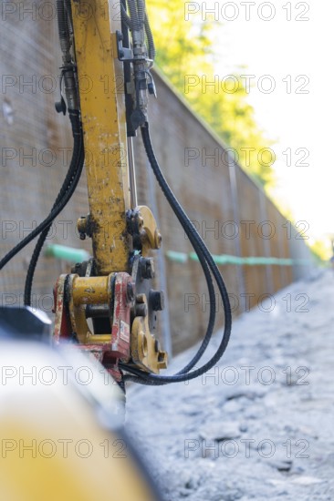 Close-up of a construction machine with hoses on a construction wall, Hermann Hessebahn construction site, Calw, Germany