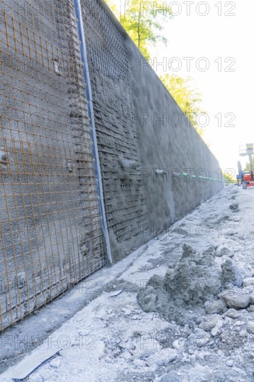 Construction site with a long concrete wall reinforced by wire mesh, Hermann Hessebahn construction site, Calw, Germany