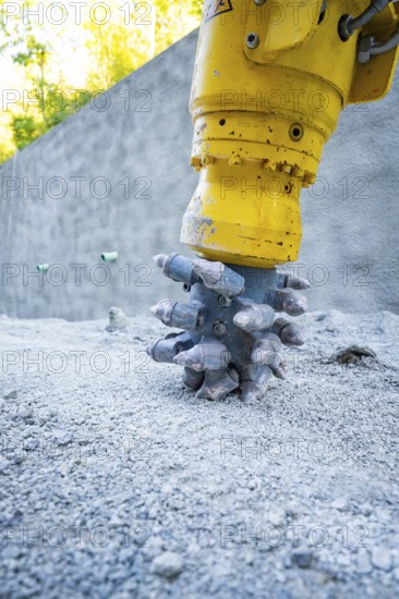 Construction machine drilling into concrete on a building site, Hermann Hessebahn building site, Calw, Germany