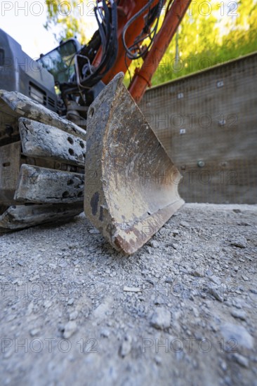 Close-up view of an excavator and its worn shovel on a construction site, Hermann Hessebahn construction site, Calw, Germany