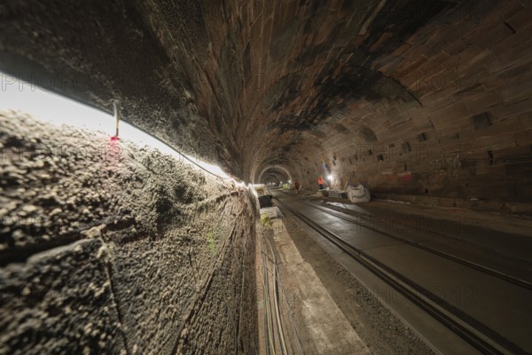Tunnel with tracks and construction work, illuminated by line lights, construction of the Hermann Hesse railway, Calw, Black Forest, Germany