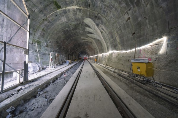 A tunnel still under construction with rails and artificial lighting, construction of the Hermann Hesse railway, Calw, Black Forest, Germany