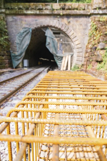 Construction site of a railway with tunnel and steel grid, surrounded by daylight and renovation work, construction of the Hermann Hesse Railway, Calw, Black Forest, Germany