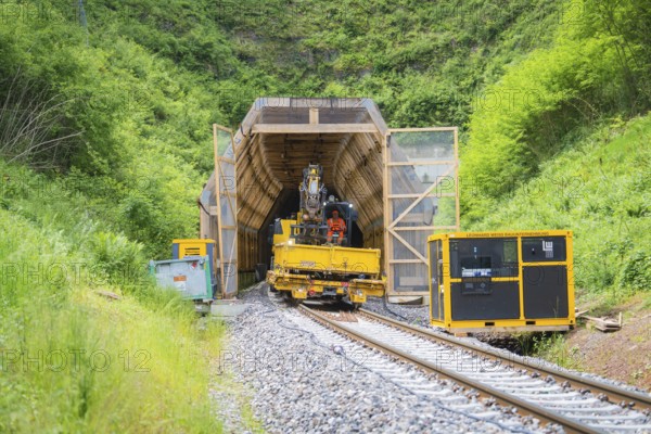 Construction vehicle near a tunnel in a green, natural environment, construction of the Hermann Hesse railway, Calw, Black Forest, Germany