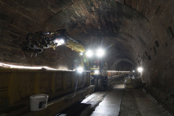 Tunnel lighting with track under construction and heavy machinery, construction of the Hermann Hesse railway, Calw, Black Forest, Germany