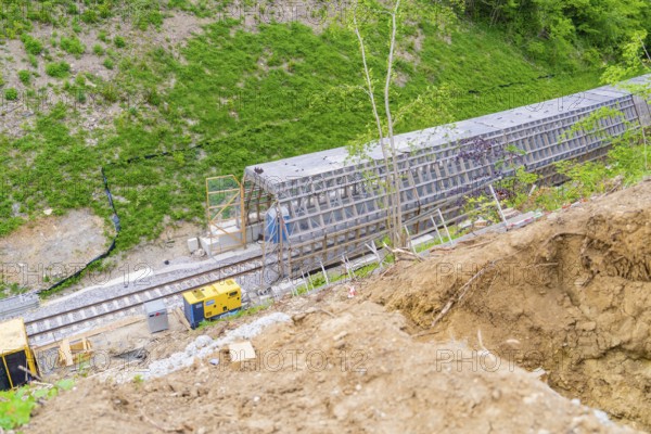 Aerial view shows railway tracks and construction work on a hill surrounded by vegetation, construction of the Hermann Hesse railway, Calw, Black Forest, Germany