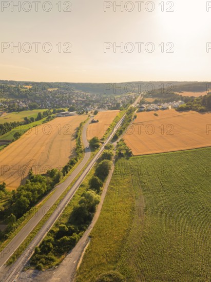 Wide landscape with road and fields at sunset, harmonious and natural surroundings, construction of the Hermann Hesse railway, Calw, Black Forest, Germany