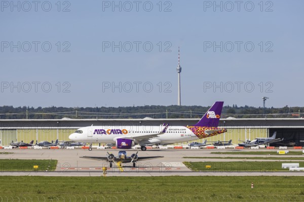 Stuttgart Airport with television tower and aeroplane on the runway. Aircraft registration: SU-BVN, Air Cairo, Airbus A320neo. Stuttgart, Baden-Württemberg, Germany