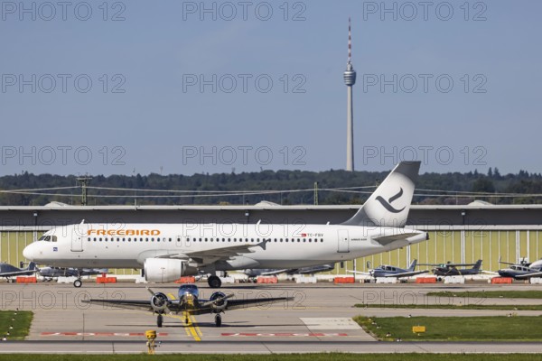 Stuttgart Airport with television tower and aeroplane. Aircraft registration number: TC-FBV, Freebird, Airlines Airbus A320-200, Stuttgart, Baden-Württemberg, Germany