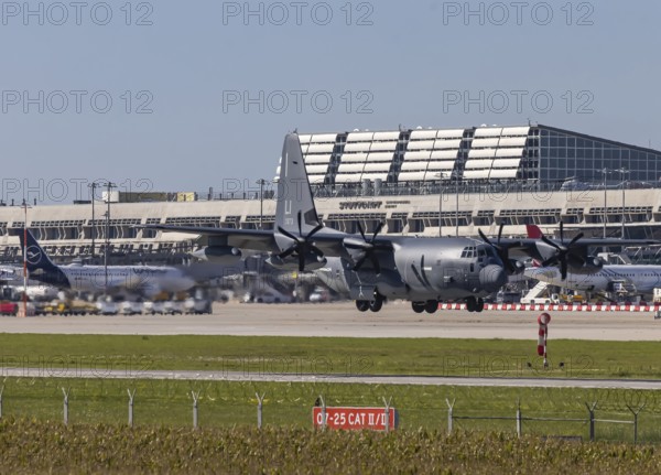 Stuttgart Airport with terminal and US Air Force Lockheed L-100 Hercules aircraft landing. Stuttgart, Baden-Württemberg, Germany