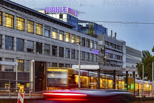 Headquarters of the automotive supplier MAHLE in the evening with the SSB tram. Bad Cannstatt, Stuttgart, Baden-Württemberg, Germany
