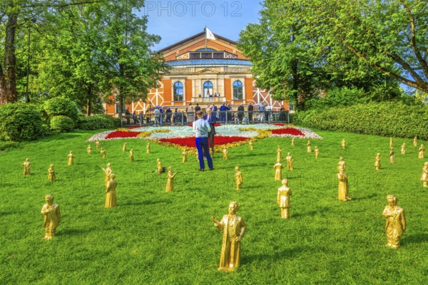 Sculptures of Richard Wagner and King Ludwig II in front of the festival theatre on the Green Hill with festival guests, festival town of Bayreuth, Upper Franconia, Franconia, Bavaria, Germany
