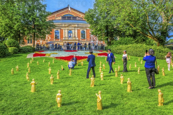 Sculptures of Richard Wagner and King Ludwig II in front of the festival theatre on the Green Hill with festival guests, festival town of Bayreuth, Upper Franconia, Franconia, Bavaria, Germany
