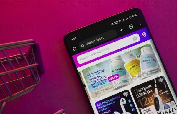Dhaka, Bangladesh- 23 June 2025: A smartphone displaying the Wildberries website with a shopping cart is shown on a vibrant background