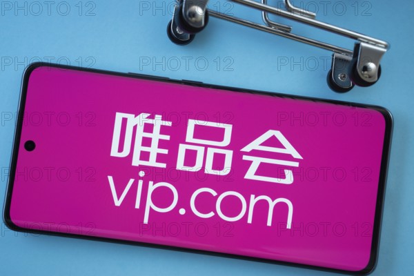 Dhaka, Bangladesh- 03 July 2025: Smartphone screen showing the vip.com logo with shopping cart wheels on a blue background