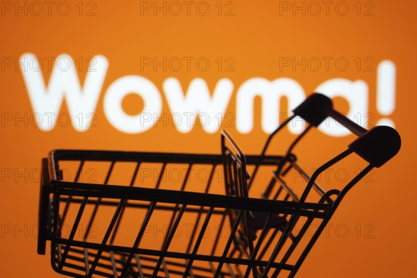 Dhaka, Bangladesh- 03 July 2025: Silhouette of a shopping cart in front of the wowma logo, symbolizing ecommerce and online shopping