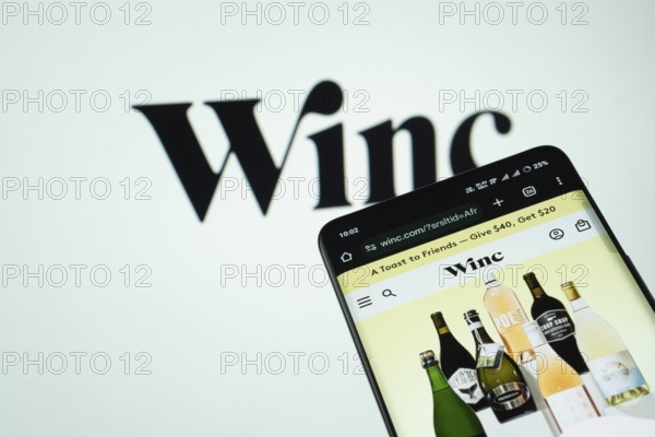 Dhaka, Bangladesh- 03 July 2025: Smartphone displaying Winc web interface against Winc logo background
